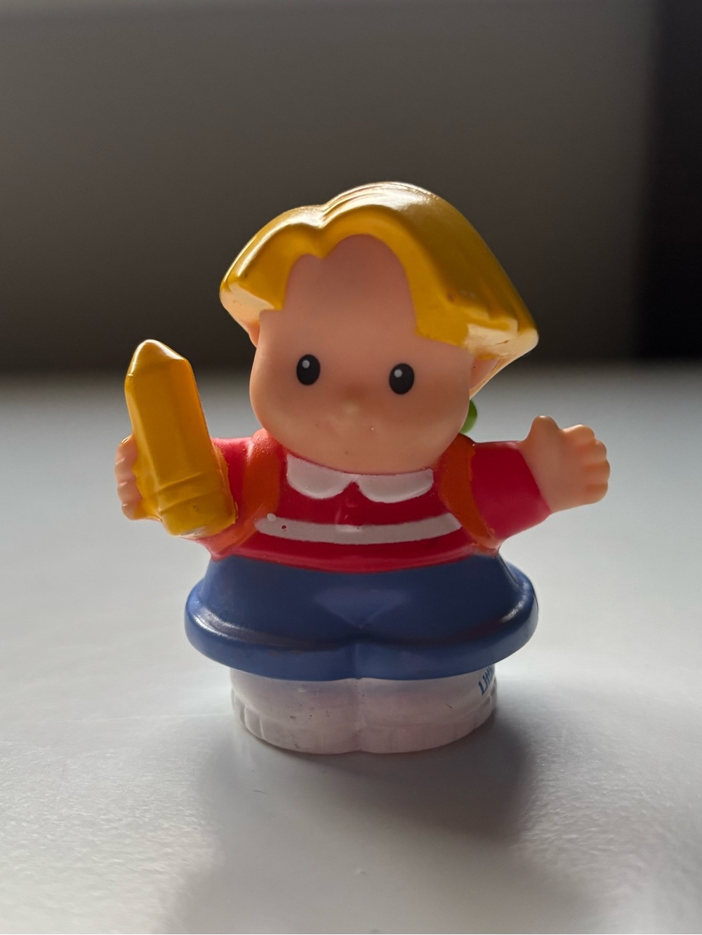 Fisher price little people “Eddie” holding a pencil/frog backpack